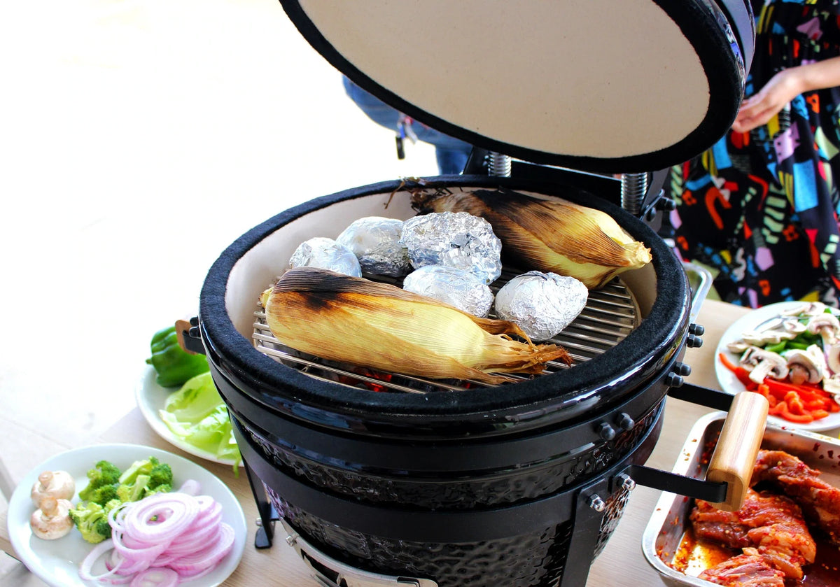 Roast chicken cooking in a ceramic grill — outdoor cooking inspiration.